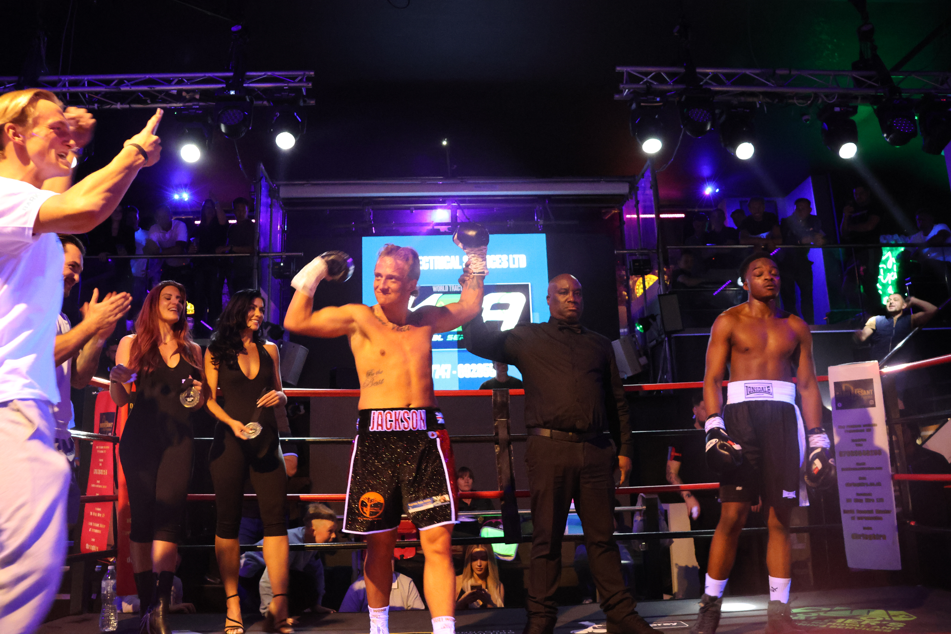 Black tie boxing event with two boxers facing off in the ring